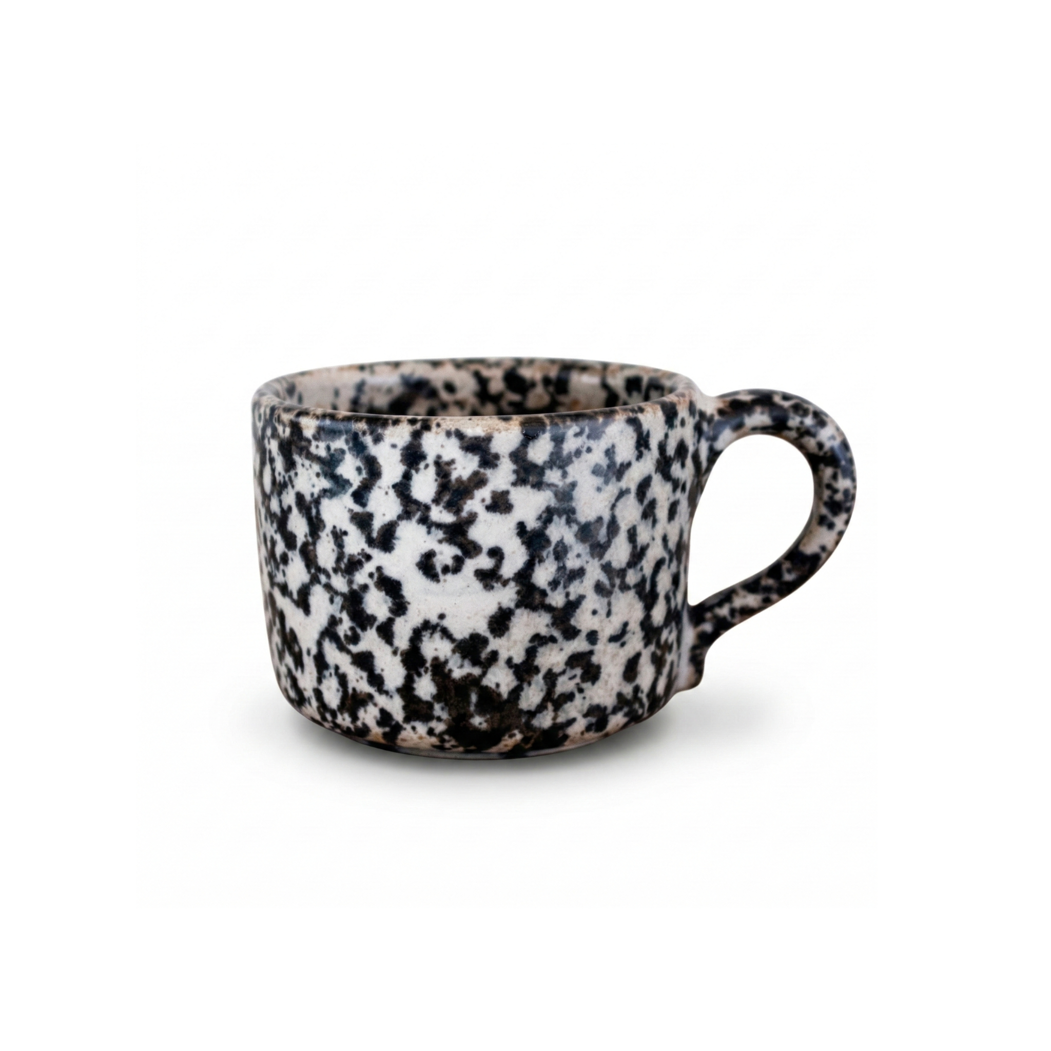 Handmade 10 oz ceramic mug featuring a rustic black and white speckled ink-blot glaze, side profile on white